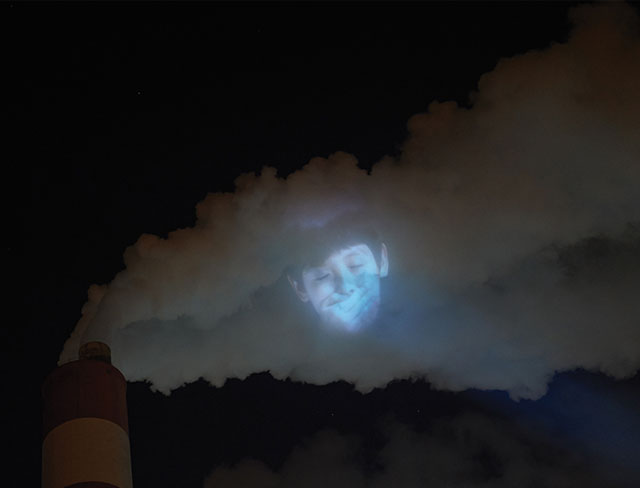 Children's Faces Projected On Factory Vapors To Protest Air Pollution In China