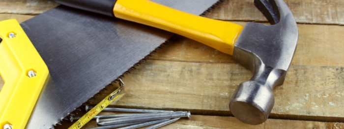 Assorted work tools on wooden decking