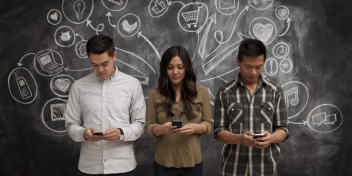 People on phones with social media icon chalkboard