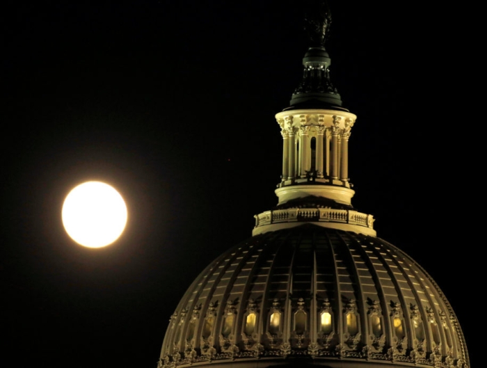 The supermoon rises over the United States Capitol dome in Washington, U.S., November 13, 2016.    REUTERS/Gary Cameron