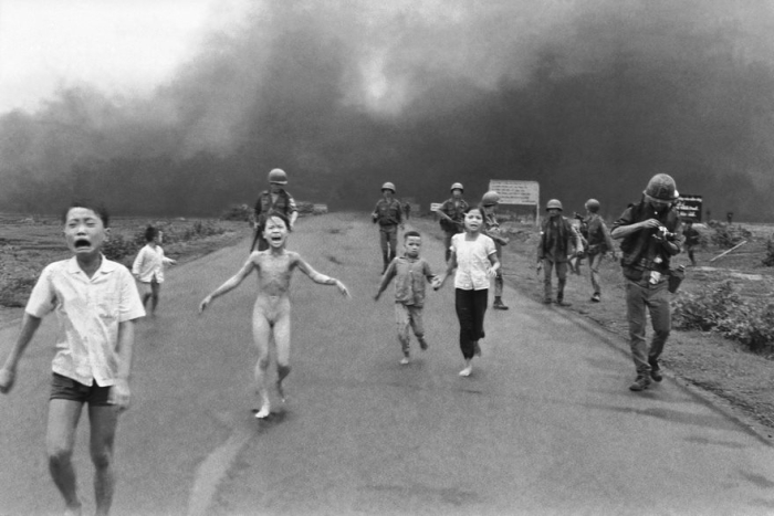 South Vietnamese forces follow after terrified children, including 9-year-old Kim Phuc, center, as they run down Route 1 near Trang Bang after an aerial napalm attack on suspected Viet Cong hiding places, June 8, 1972. A South Vietnamese plane accidentally dropped its flaming napalm on South Vietnamese troops and civilians. The terrified girl had ripped off her burning clothes while fleeing. The children from left to right are: Phan Thanh Tam, younger brother of Kim Phuc, who lost an eye, Phan Thanh Phouc, youngest brother of Kim Phuc, Kim Phuc, and Kim's cousins Ho Van Bon, and Ho Thi Ting. Behind them are soldiers of the Vietnam Army 25th Division. (AP Photo/Nick Ut)
